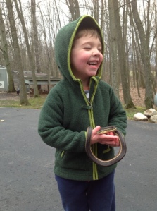 The author's son holding a new friend, an eastern garter snake